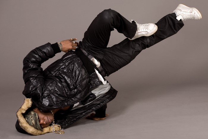 Man in a black puffer jacket dancing