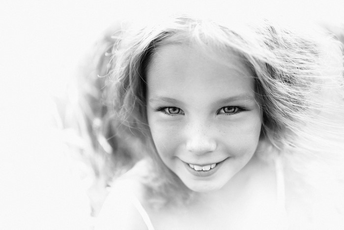 Black and white portrait of a smiling young girl