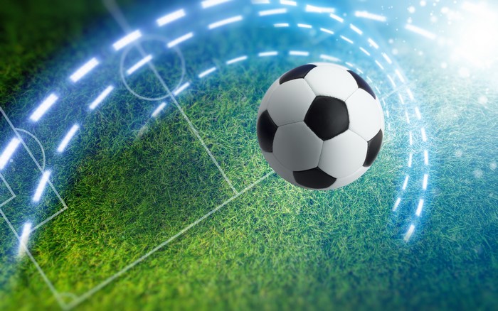 4K Football on a Grassy Field with Glowing Lines