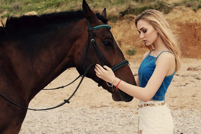 Blonde girl with brown horse