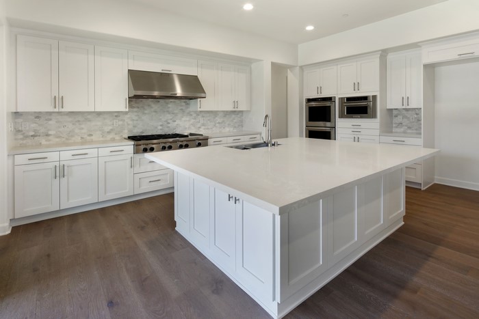 Modern White Kitchen with Island and Stainless Steel Appliances