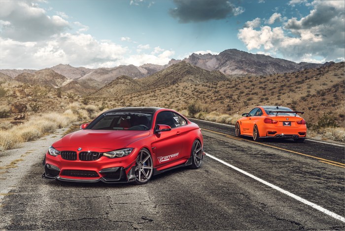 Red and Orange BMW M4s on a Desert Road