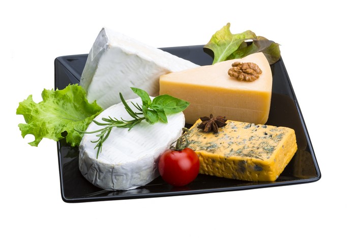 Cheese platter with nuts and vegetables