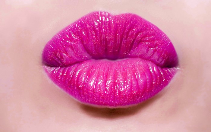 Close-up of glossy pink lips