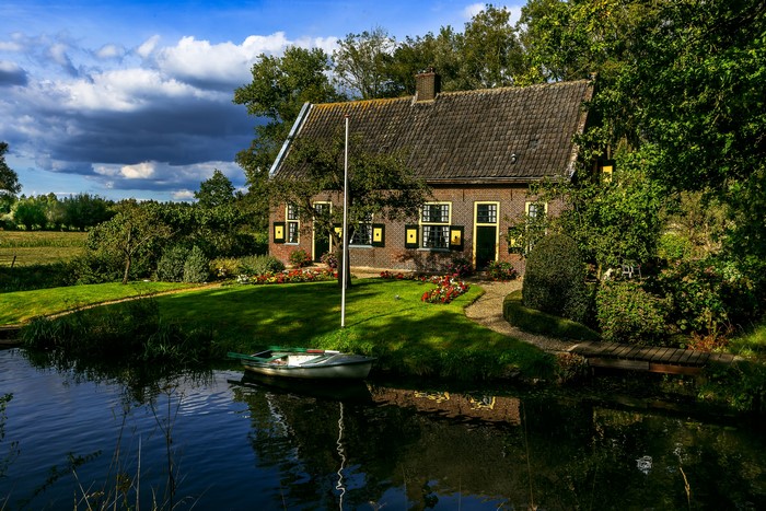 Brick house with a canal and boat in Utrecht, Netherlands