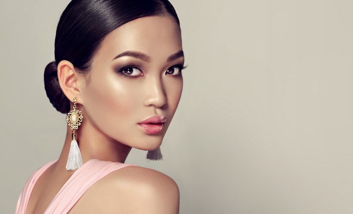 Asian woman with elegant earrings and makeup