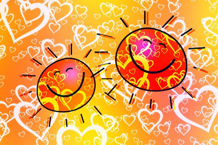 Two smiling suns with hearts on an orange background