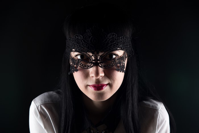 Woman wearing a black lace mask