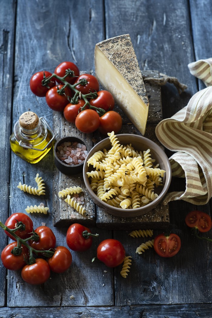 4K Cheese, Tomatoes, and Pasta on Wood