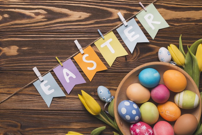 Easter banner with eggs and tulips on wood