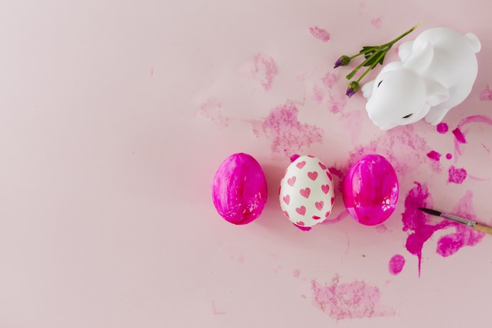 Easter eggs and bunny on pink background