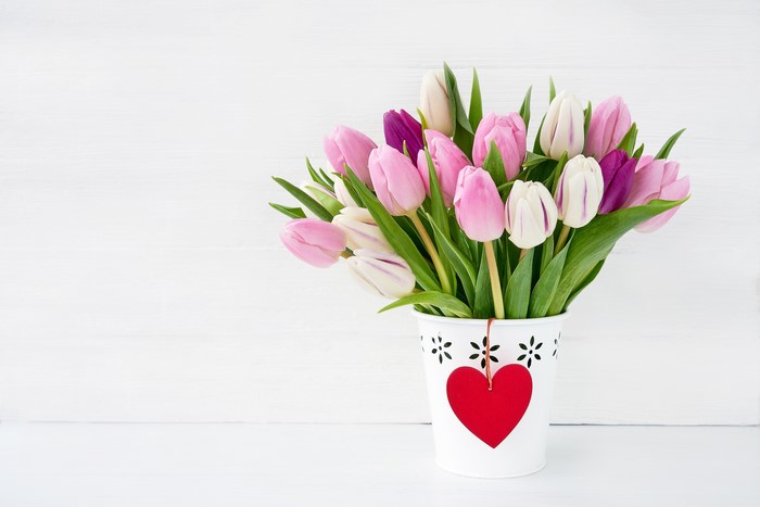 Tulips in a vase with a heart decoration