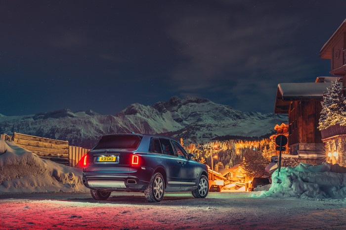 Rolls-Royce Cullinan in snowy mountains at night