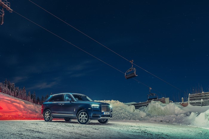 Rolls-Royce Cullinan in snowy ski resort at night