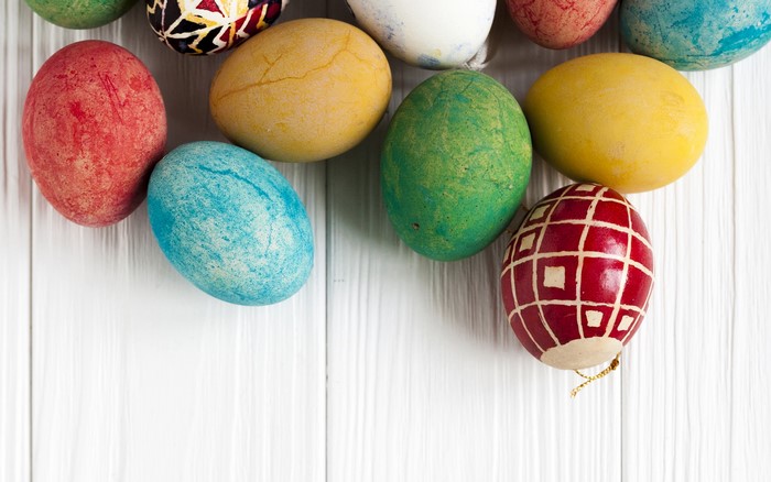 Colorful Easter eggs on white wooden planks