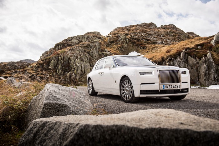 White Rolls-Royce Phantom on a rocky mountain road