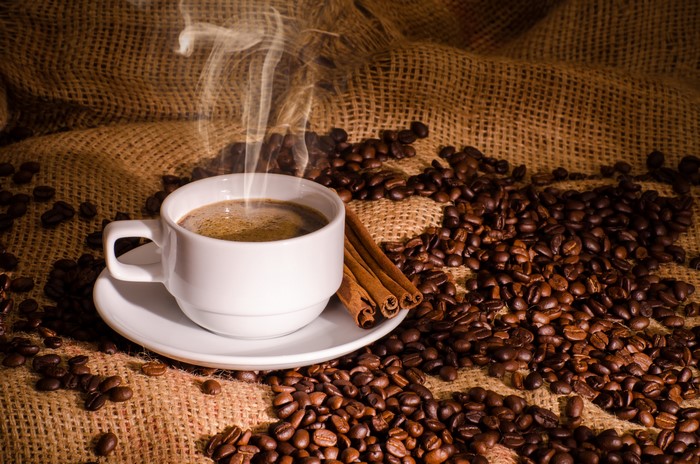 Cup of Coffee with Cinnamon and Beans