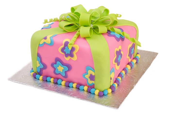 Square cake decorated as a gift with flowers and a bow