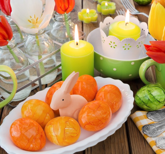 Easter table setting with tulips, candles, and eggs