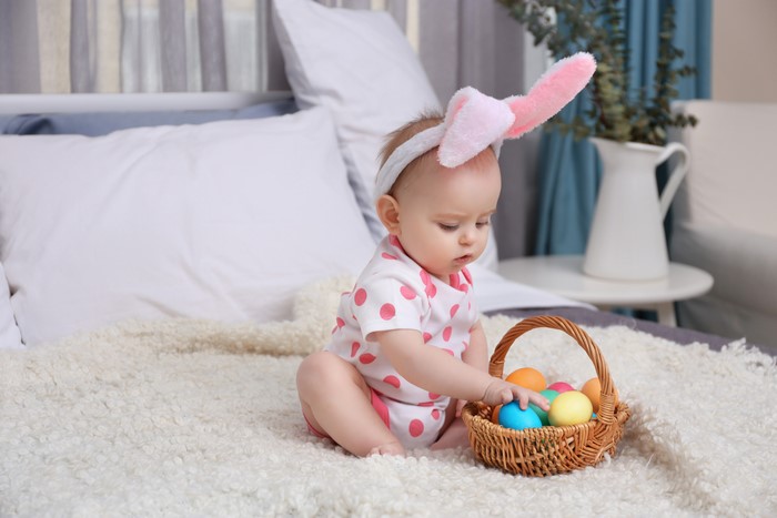Baby with Easter Eggs in Wicker Basket