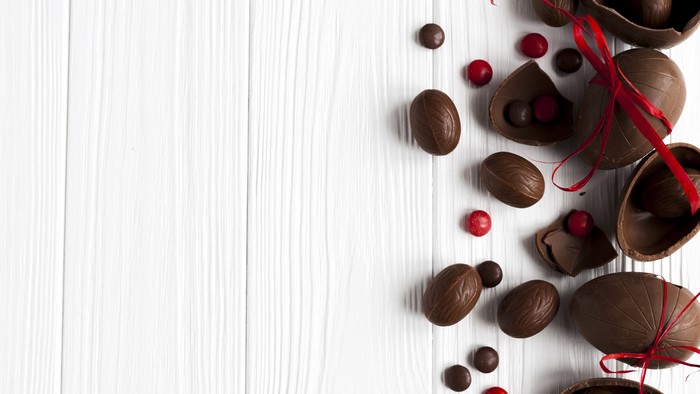 Easter Chocolate Eggs and Candies on Wood Planks