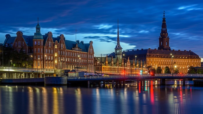 Copenhagen cityscape at dusk with canals and historic buildings