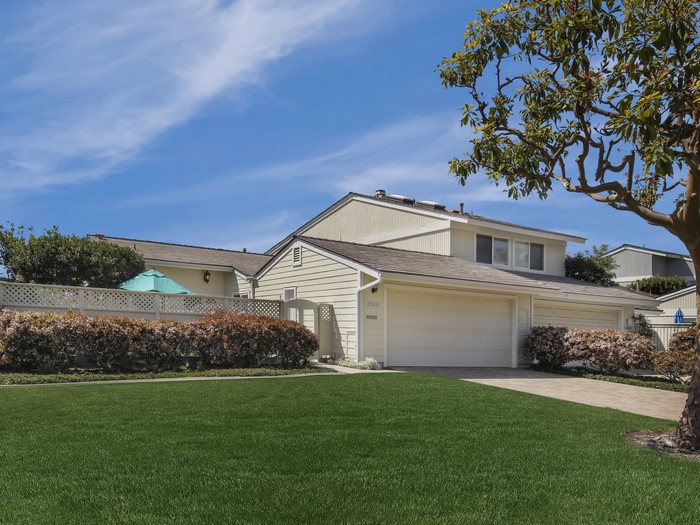 Two-story house with attached garage and manicured lawn