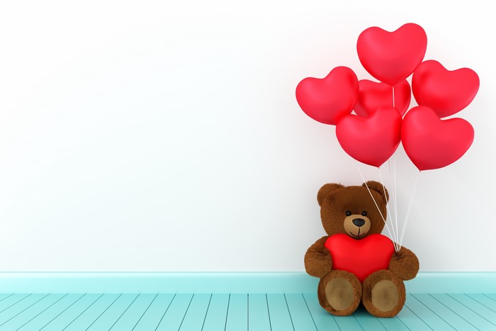 Teddy bear with red heart balloons