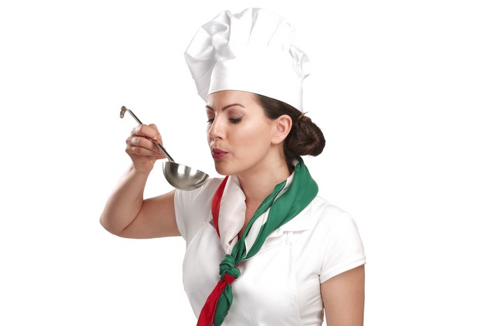 Chef tasting food with ladle