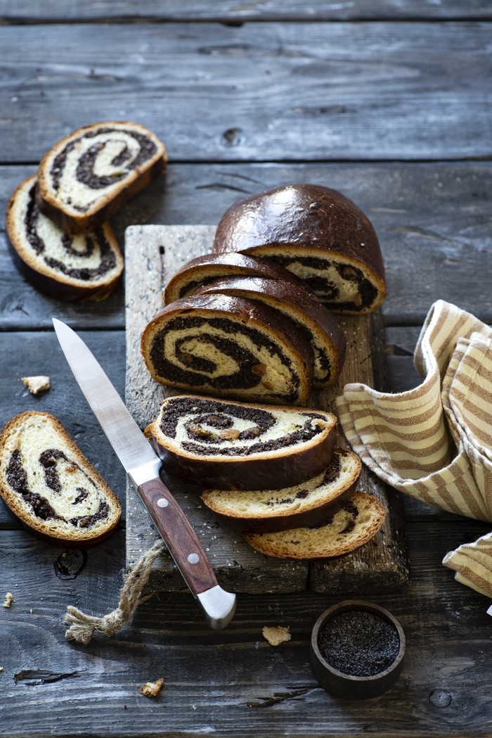 Poppy seed roll on a cutting board with a knife