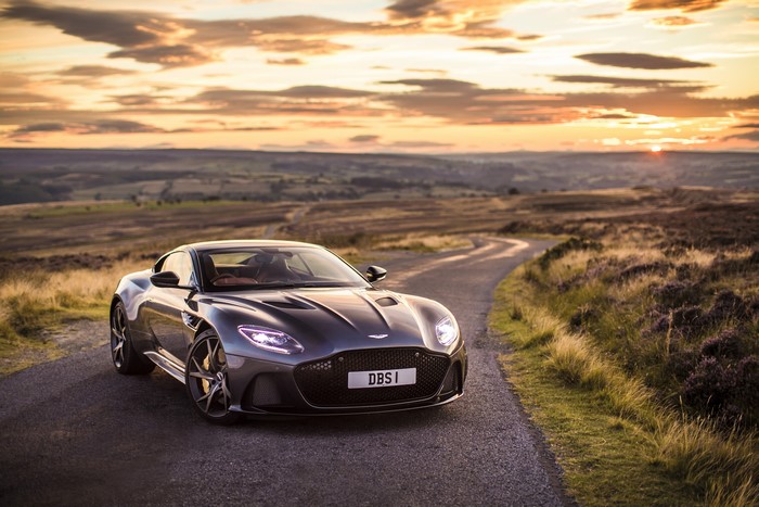 Aston Martin DBS Superleggera on a winding road at sunset
