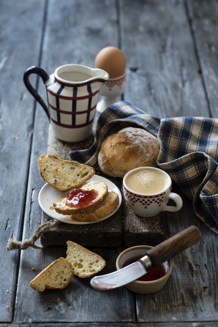 Breakfast with coffee, bread, jam, and egg