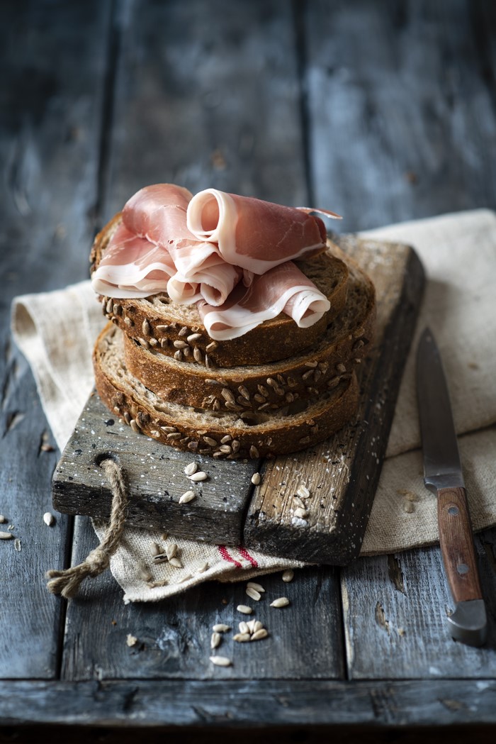 Bread with Ham and Knife on Wood