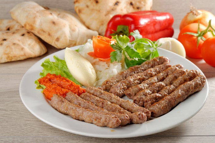 Plate of grilled meat with vegetables and bread