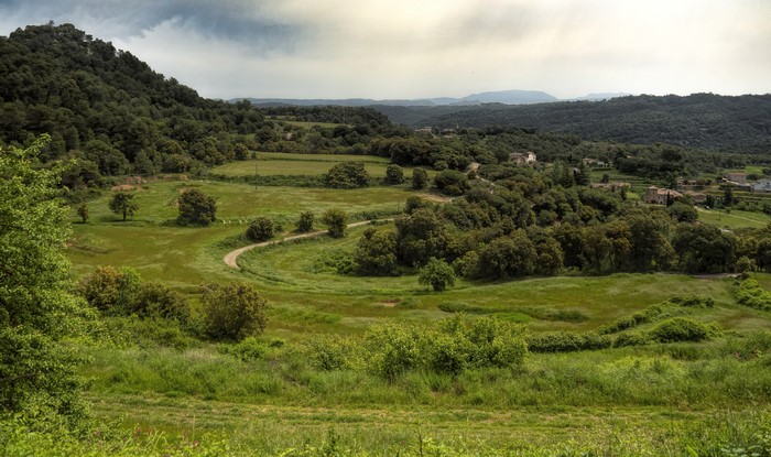 Rural landscape with rolling hills and scattered houses in Granera, Catalonia, Spain