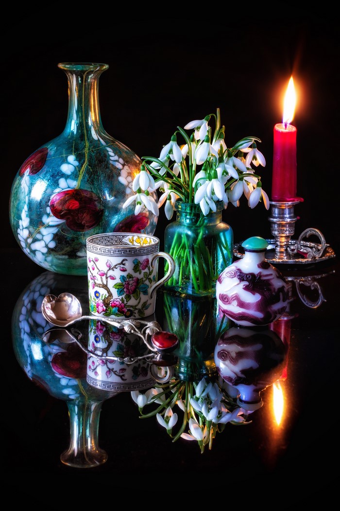 Still-life with snowdrops, cup, spoon, and candle