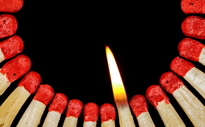4K Closeup of a lit match surrounded by unlit matches