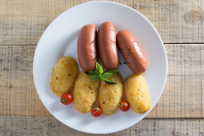 Sausages and potato croquettes on a plate