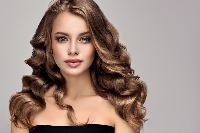 Woman with long curly brown hair