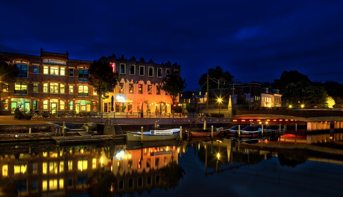 Amersfoort canals at night with illuminated buildings and boats