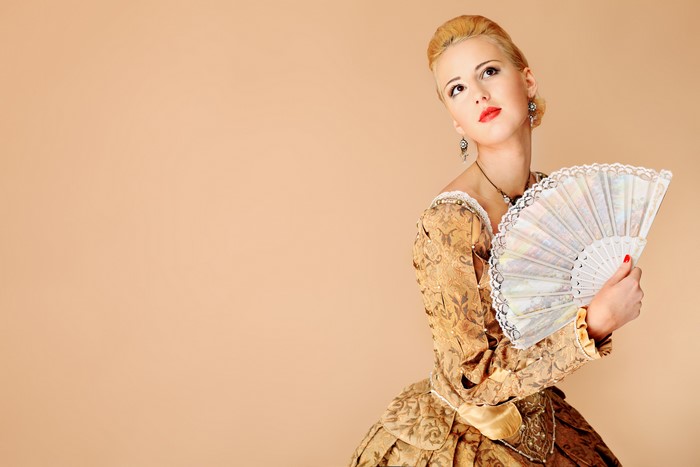 Woman in historical dress holding a fan
