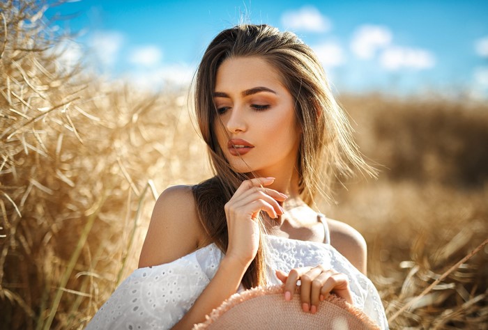 Woman with brown hair in a field