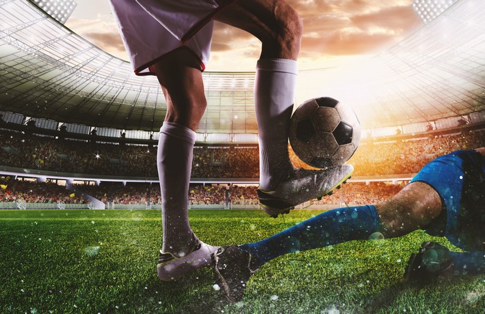 Soccer players in a stadium with a ball