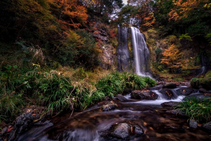 Waterfall in Autumn Forest with Stones