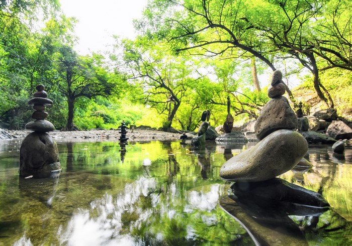 Balanced Stones Sculptures over Calm Pond in Spring Park