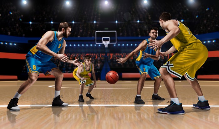 Basketball players in uniform on court