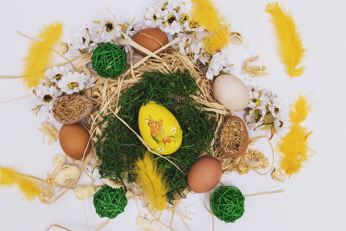 Easter eggs and decorations on straw