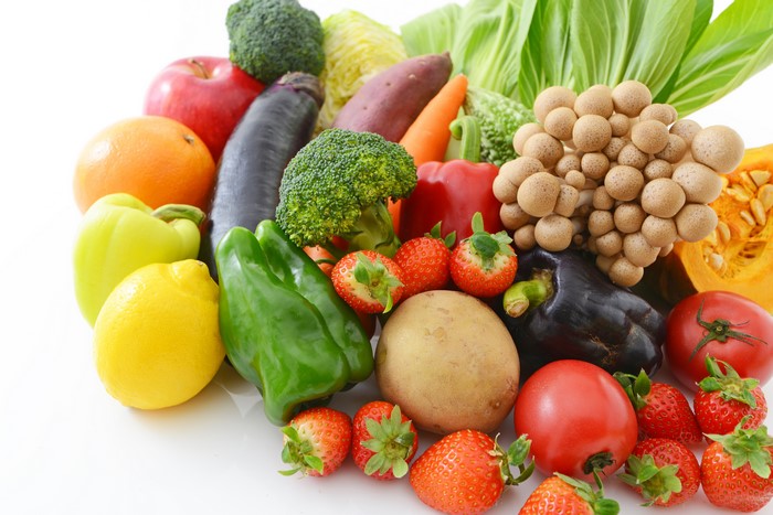 Assortment of fresh fruits and vegetables on white background