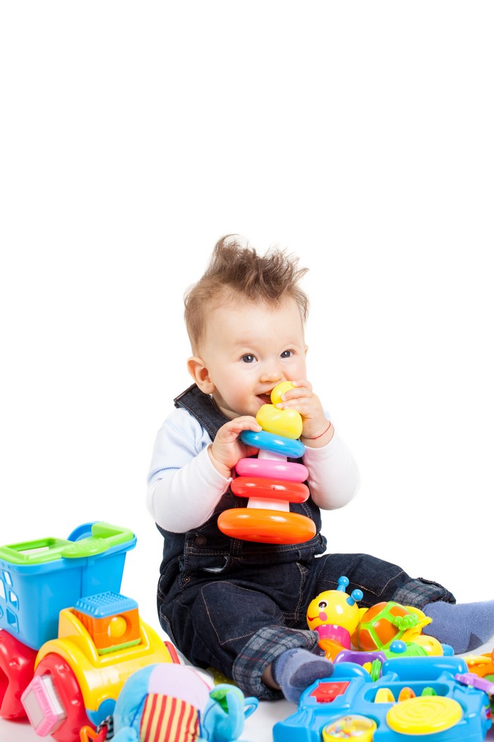 Baby playing with colorful stacking rings and toys