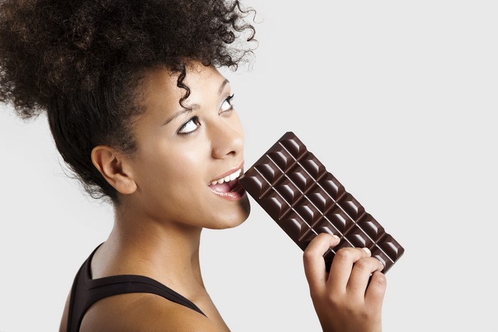 Woman eating a chocolate bar